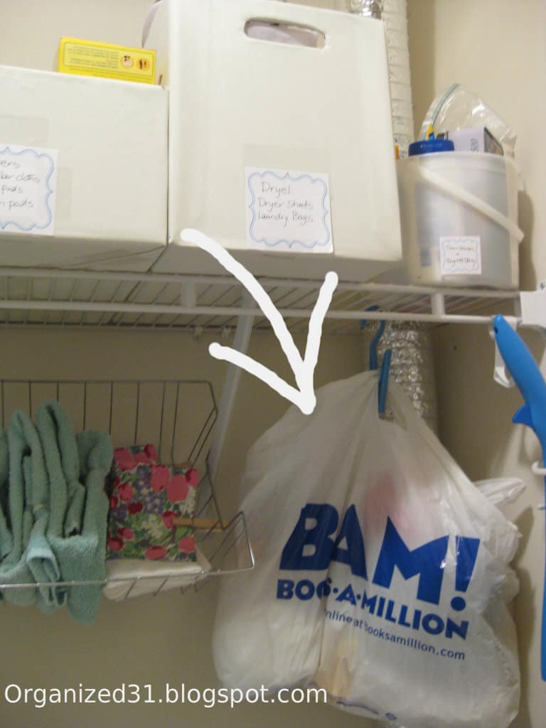laundry room shelf with arrow pointing to plastic bags.