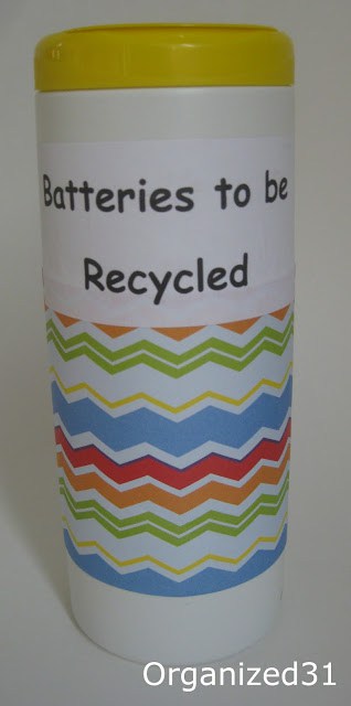 a repurposed wipes container covered in decorative paper and a label with text reading Batteries to be Recycled