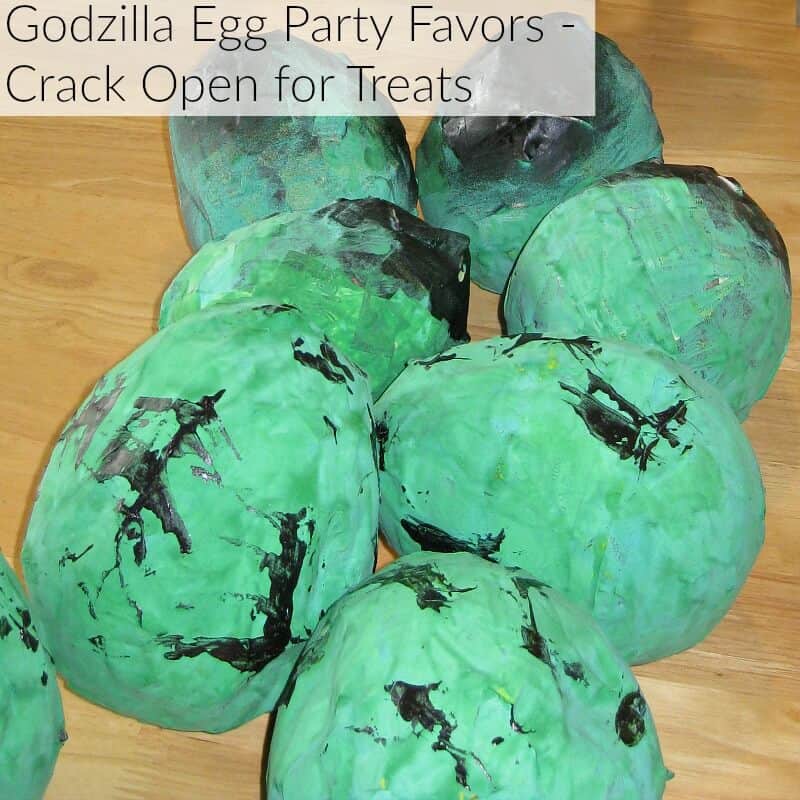 party favors that look like green eggs with title text reading Godzilla Egg Party Favors Crack Open for Treats