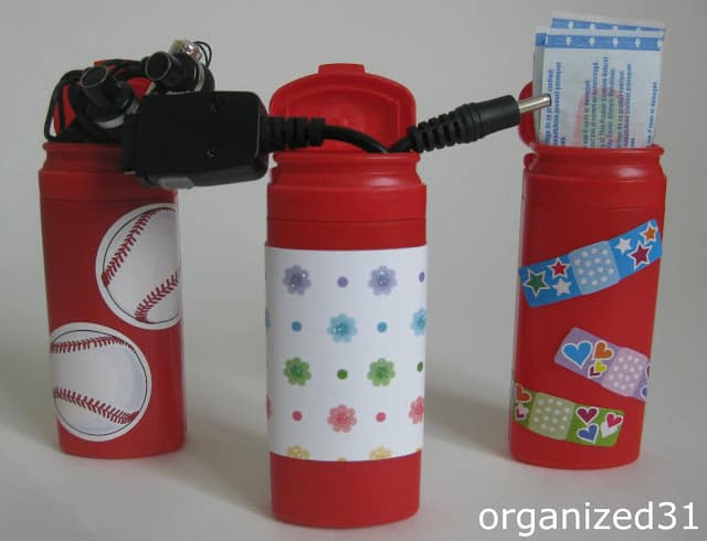 3 repurposed mentos containers for holding cords and bandaids