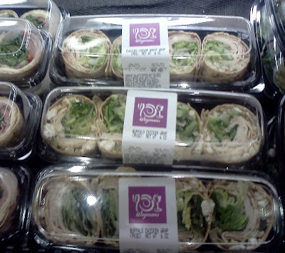 sandwich wraps in trays in a store.