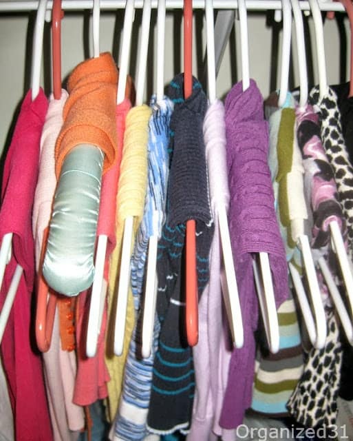 sweaters hung in a closet