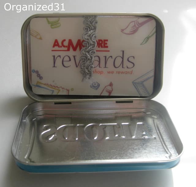rewards cards being held in a tin by a ribbon