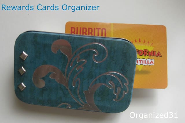 a decorative tin with a card in it with title text reading Rewards Cards Organizer