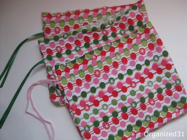 Christmas fabric gift bags with green and pink ribbons on them