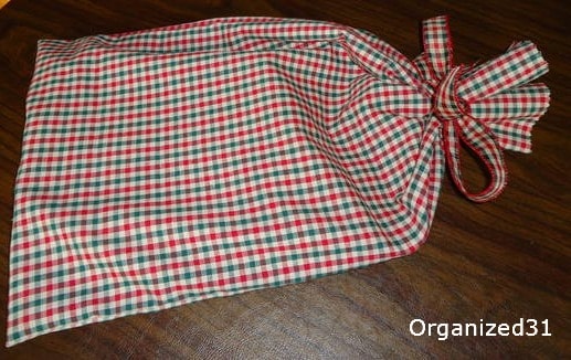 a red and green plaid cloth gift bag
