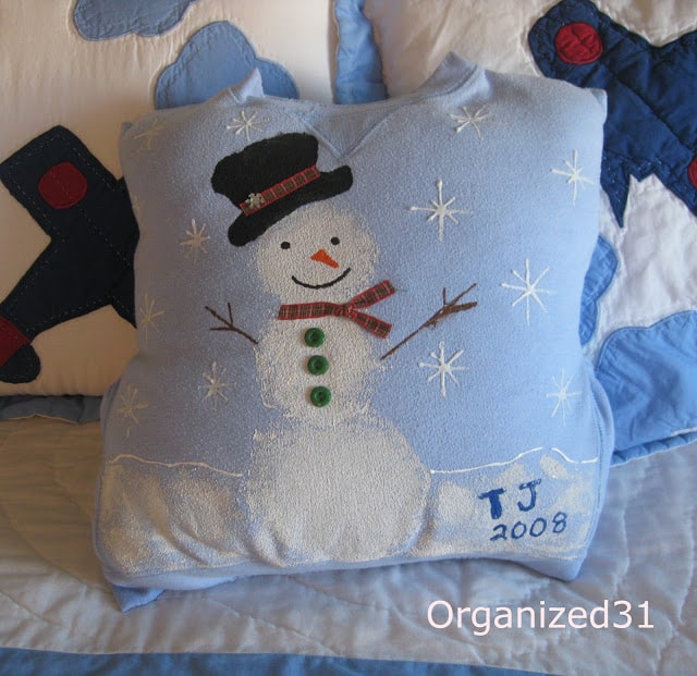 a snowman pillow on a bed