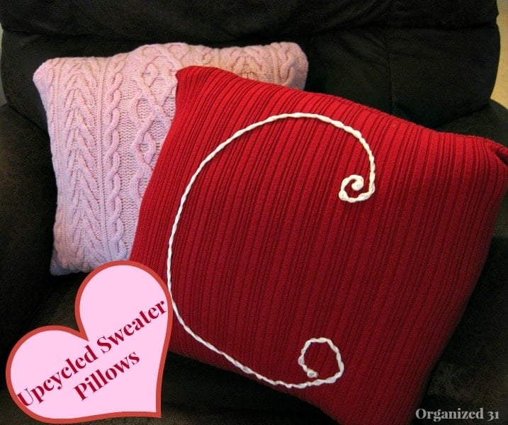 Pink and Red Sweater Pillows with text in a heart graphic reading Upcycled Sweater Pillows