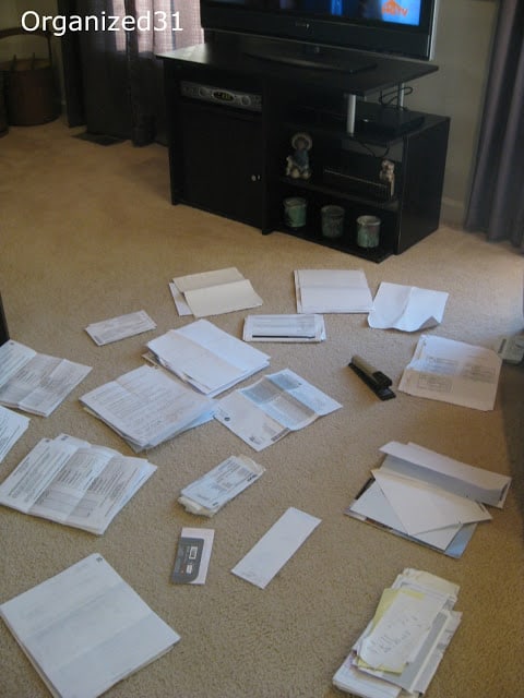 papers separated into several different piles in front of the television