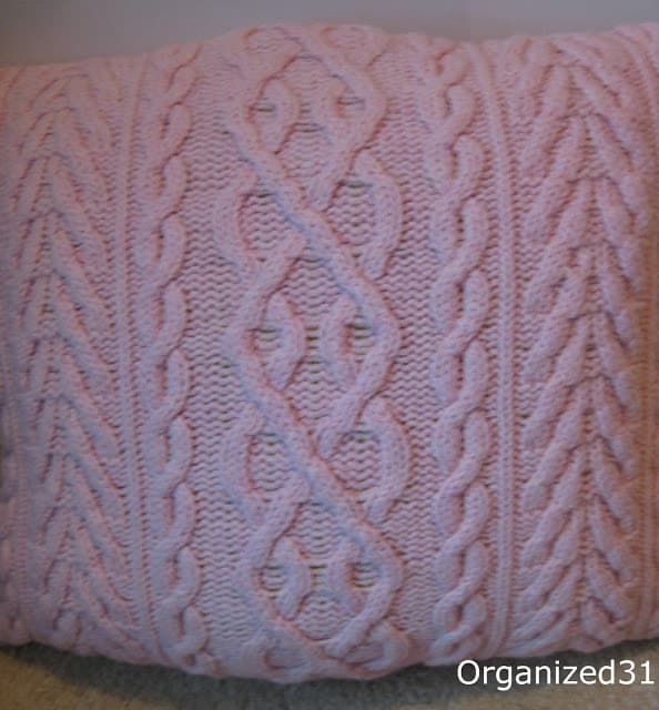a pink sweater pillow