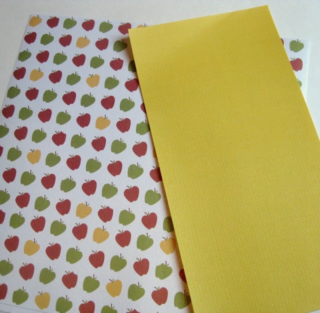 decorative paper with apples on it and yellow paper