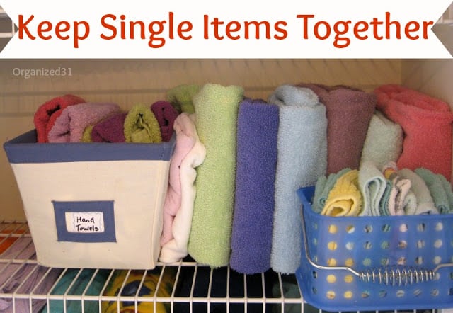 towels filed in containers and on a wire shelf in a cupboard with title text reading Keep Single Items Together