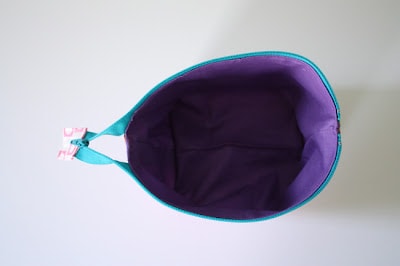 overhead view of purple inside of unzipped pouch.
