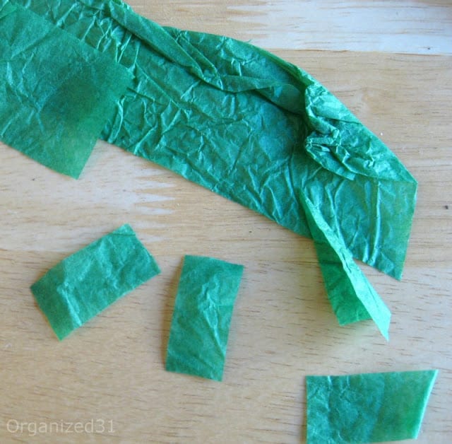 green tissue paper squares on wood table
