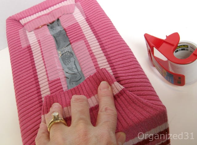 showing how to cover a box with a sweater and where to tape the sweater on the bottom of the box