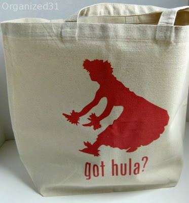 a tote bag with a red image of a lady hula dancing and text reading got hula?