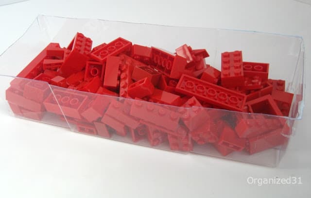 red lego bricks organized in a plastic container