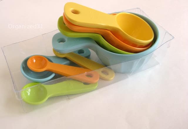 measuring cups and spoons organized in a plastic container