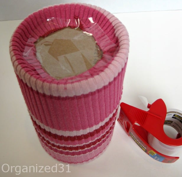 showing where to put the tape on the bottom of the upcycled sweater container
