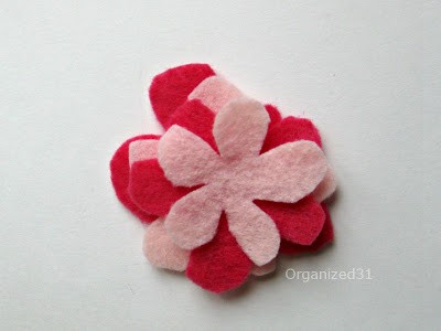 a stack of red and pink felt flowers