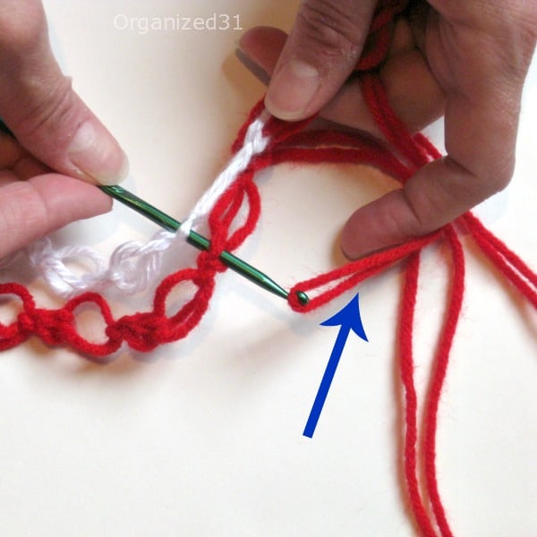 showing how to crochet 2 chains of yarn together