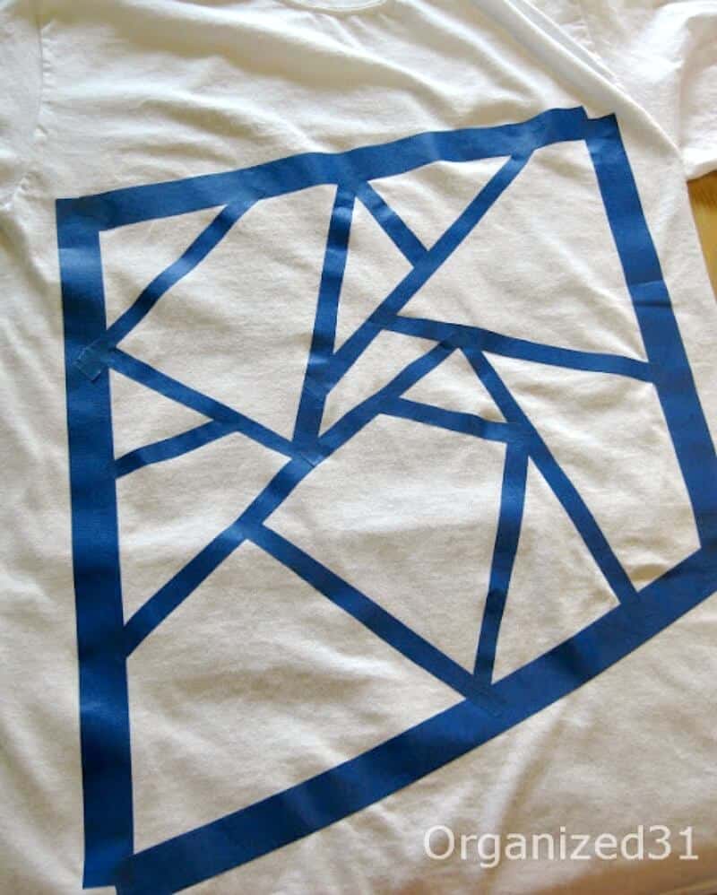 a white t-shirt with blue tap on it making a design.