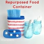 red, white and blue container with straws and blue glass jars nearby 
