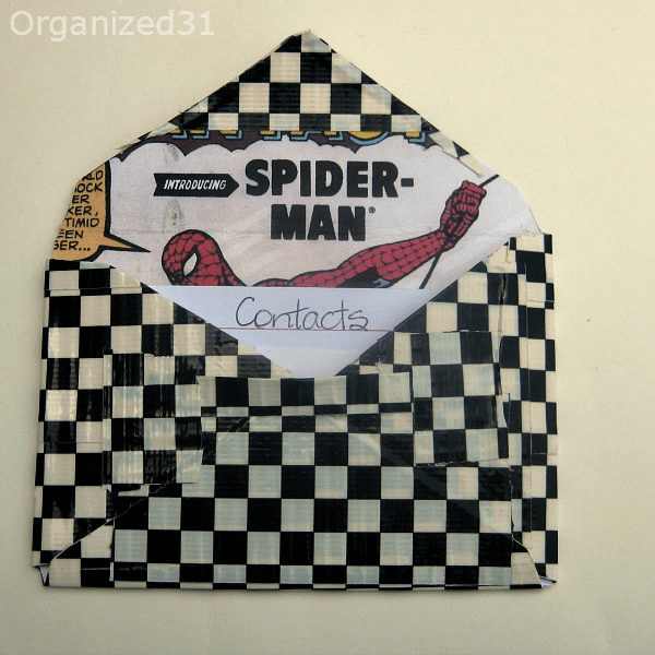 DIY Spider-man Duck tape wallet holding an index card titled Contacts.