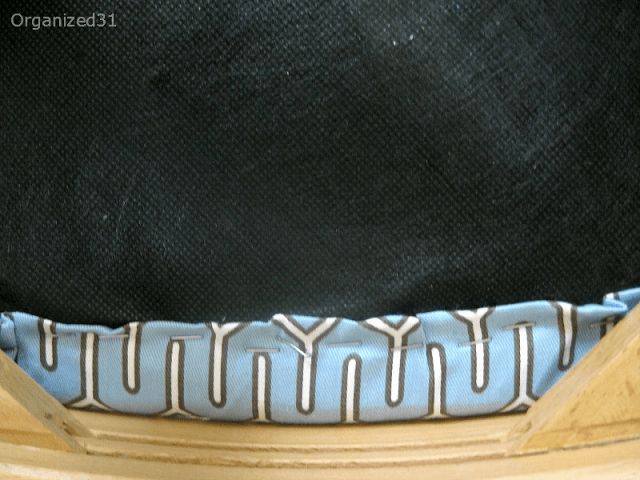 close-up view showing how fabric is attached to a chair cushion.