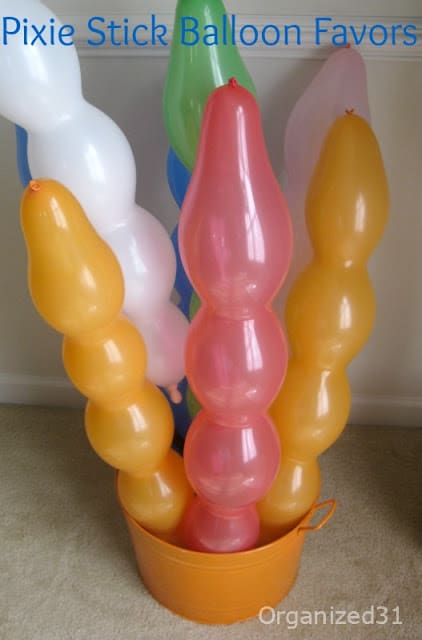 Candy-filled balloons for fun party favors with title text reading Pixie Stick Balloon Favors