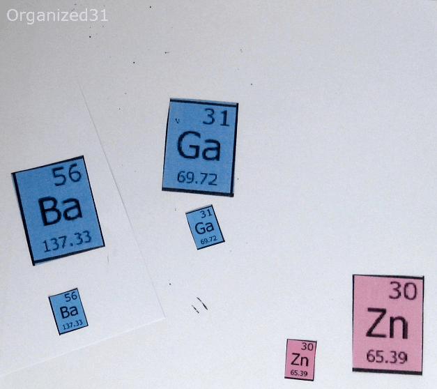 3 elements cut out from periodic table, one has "Ba", one had "Zn" and the other has "Ga" on them in both larger and smaller sizes