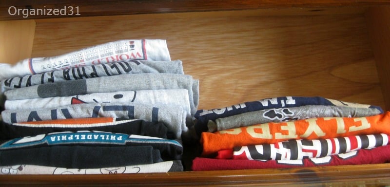 t-shirts neatly folded and filed in open drawer.