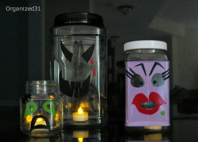 3 decorated plastic jars with battery candles lighting them up