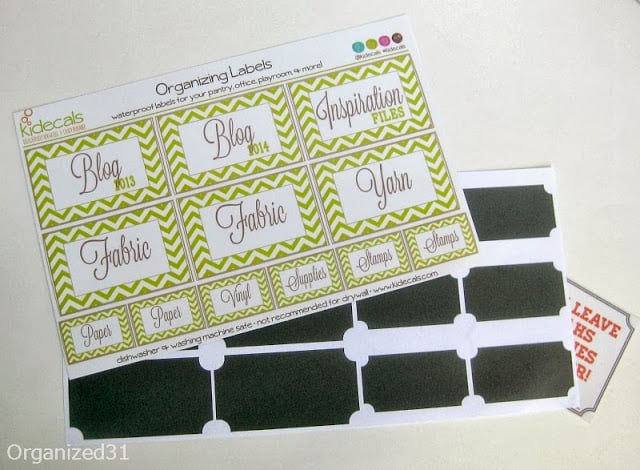 sheet of green striped labels and black chalkboard labels on white table
