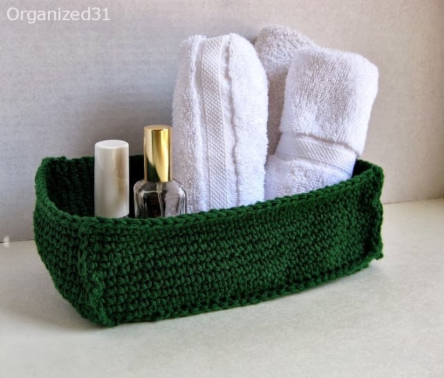 washcloths and makeup items in a green Crochet Basket 