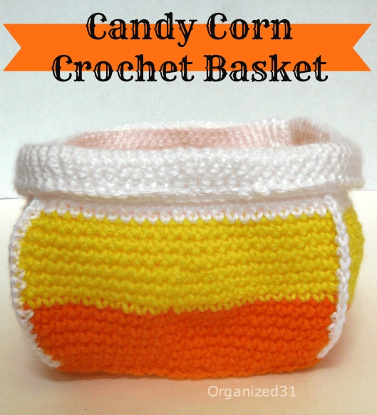 crocheted basket with orange, yellow, and white stripes like candy corn.