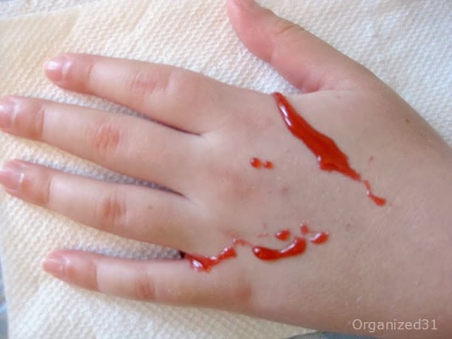 hand covered in special effects blood made from household items.