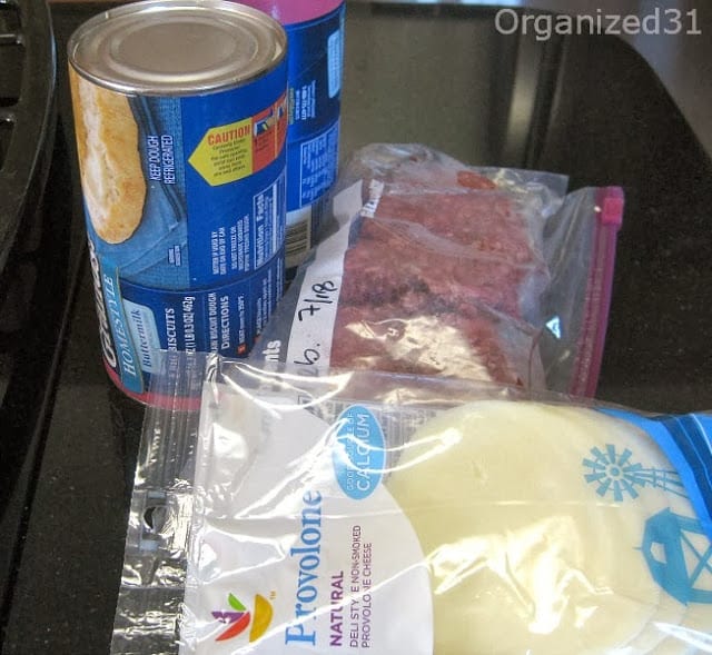 2  blue biscuit tubes, bag of ground beef and package of provolone cheese