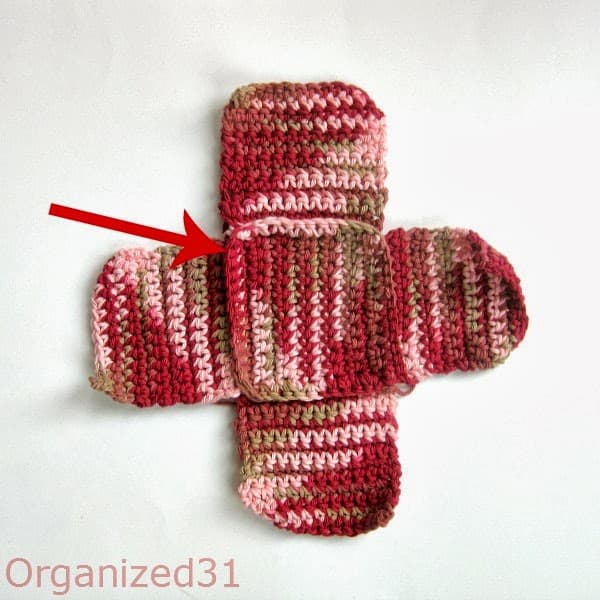 an arrow pointing to show how the crocheted squares are attached