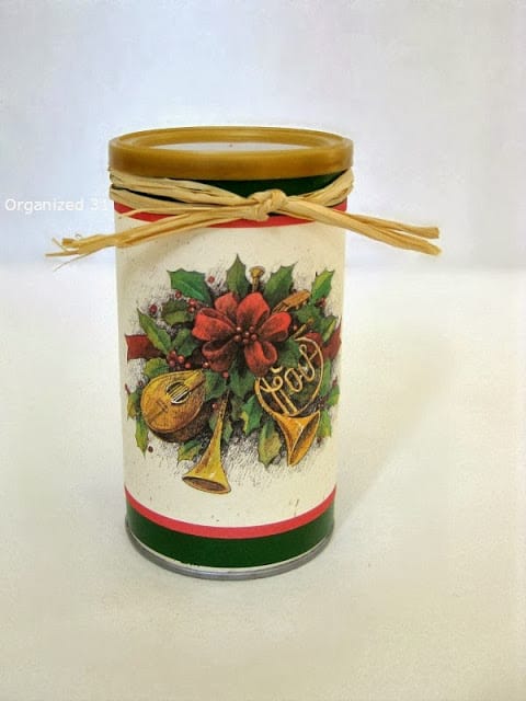 a Christmas card and ribbon wrapped around a can.