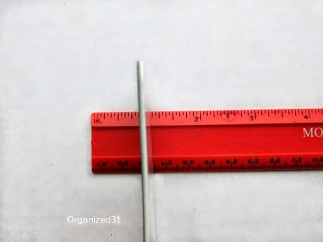 a metal rod on a red ruler