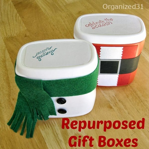 Repurposed Plastic Container Snowman Gift Box and Santa gift box on a brown table with title text reading Repurposed Gift Boxes