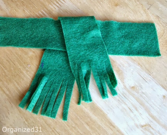 green felt being used to make a scarf