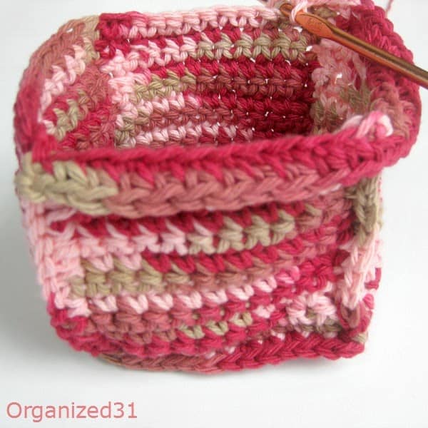 showing a needle on a crocheted basket