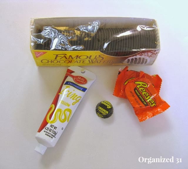 chocolate wafer cookies, yellow icing tube, reeses candy