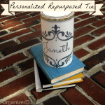 a decorative tin on top of a stack of boooks on bricks with title text reading Personalized Repurposed Tin