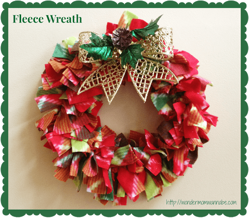 red fabric wreath with gold bow with title text reading Fleece Wreath