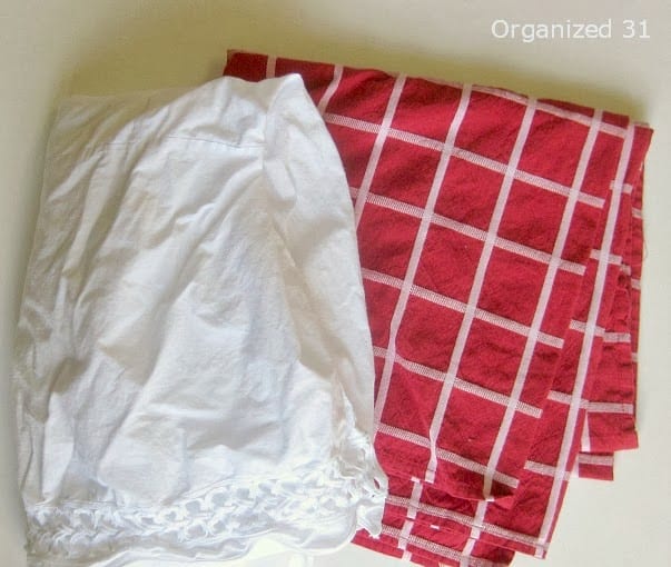 a white bed skirt and red tablecloth