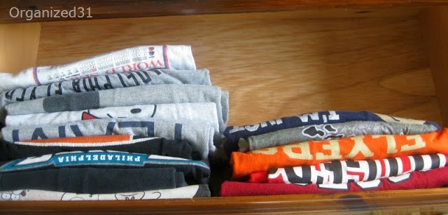 overhead view of folded shirts filed in drawer
