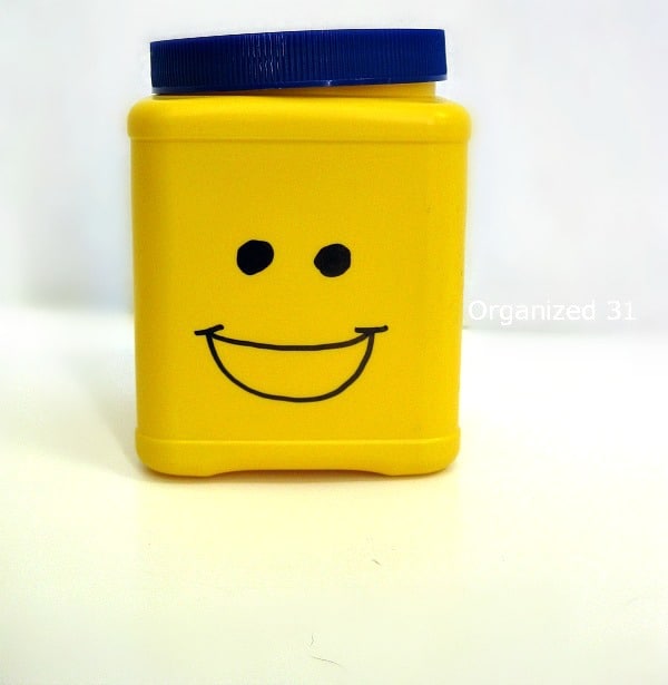 Yellow storage can with first step of smiling face drawn on